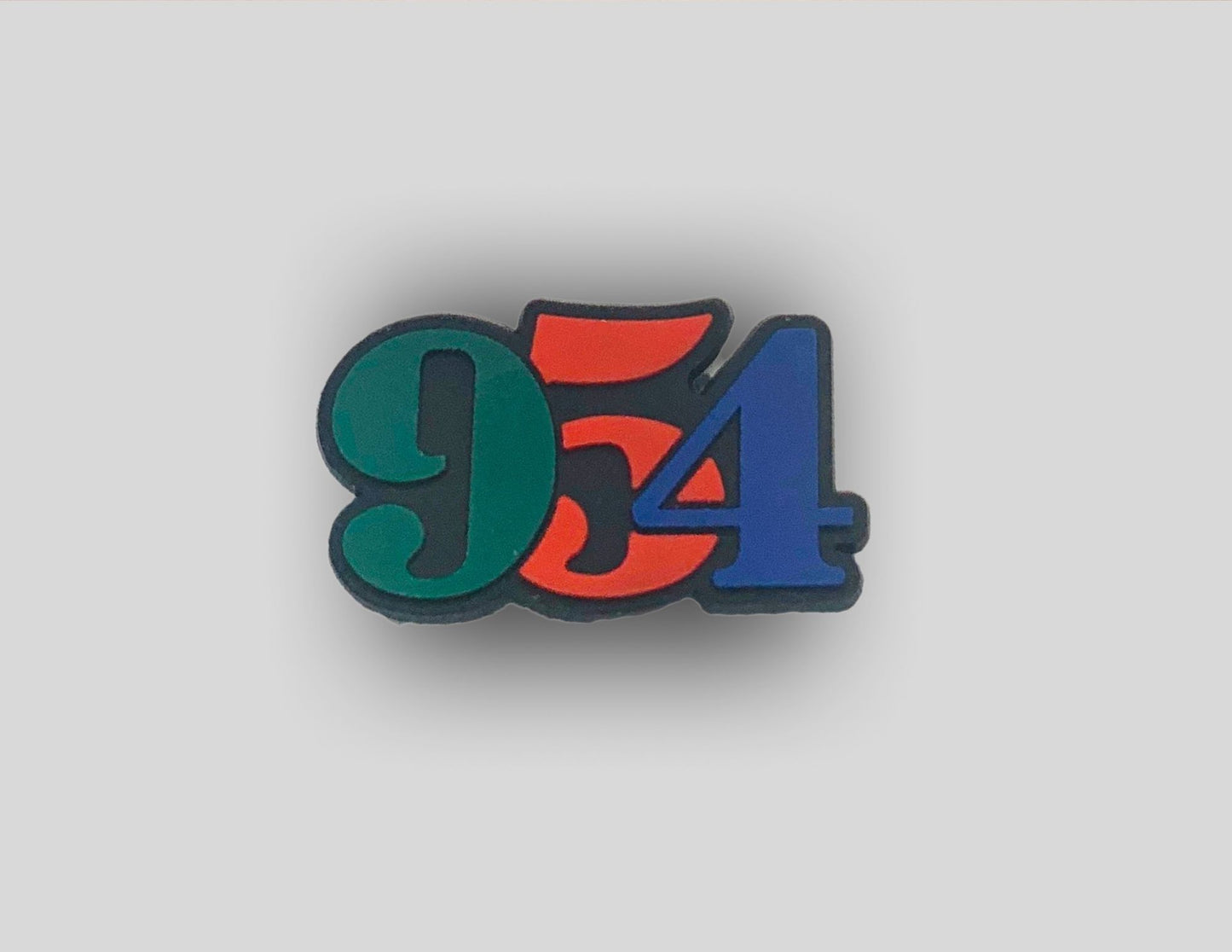 Malcontents 954 Broward County area code Croc Charm/Jibbitz shows the green, red, and blue area code in retro numbers.