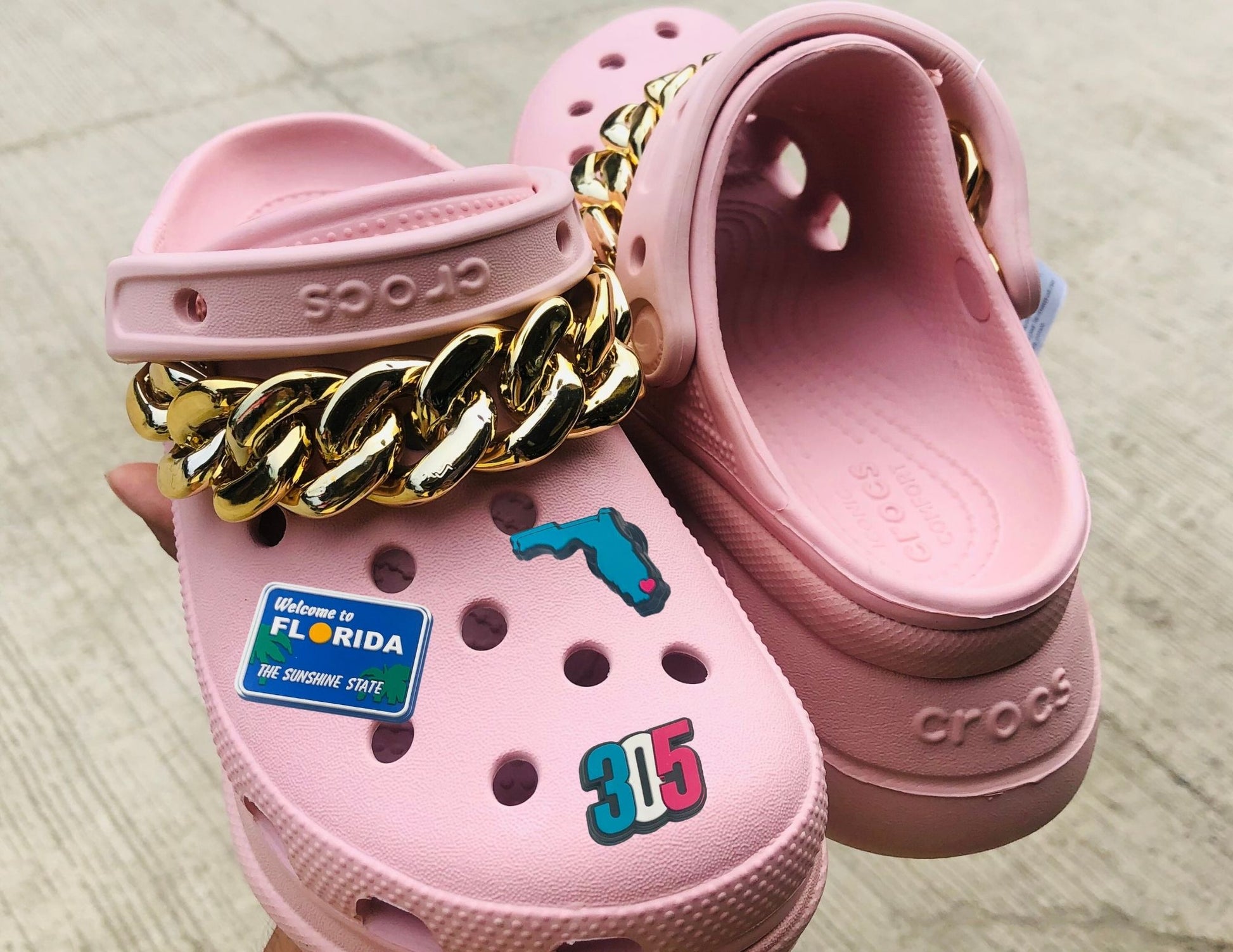 Malcontents Croc Charms/Jibbitz: Five of our best sellers from Florida- Welcome to FL, Beach Babe, 954, 305, and I Heart Florida on pink Crocs