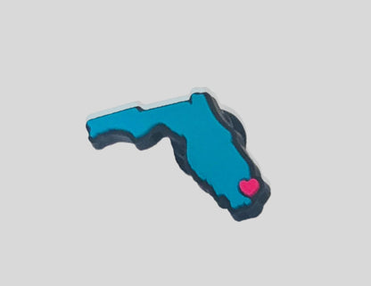 Malcontents I Heart Florida Croc Charm/Jibbitz shows the state of Florida in blue with a pink heart.