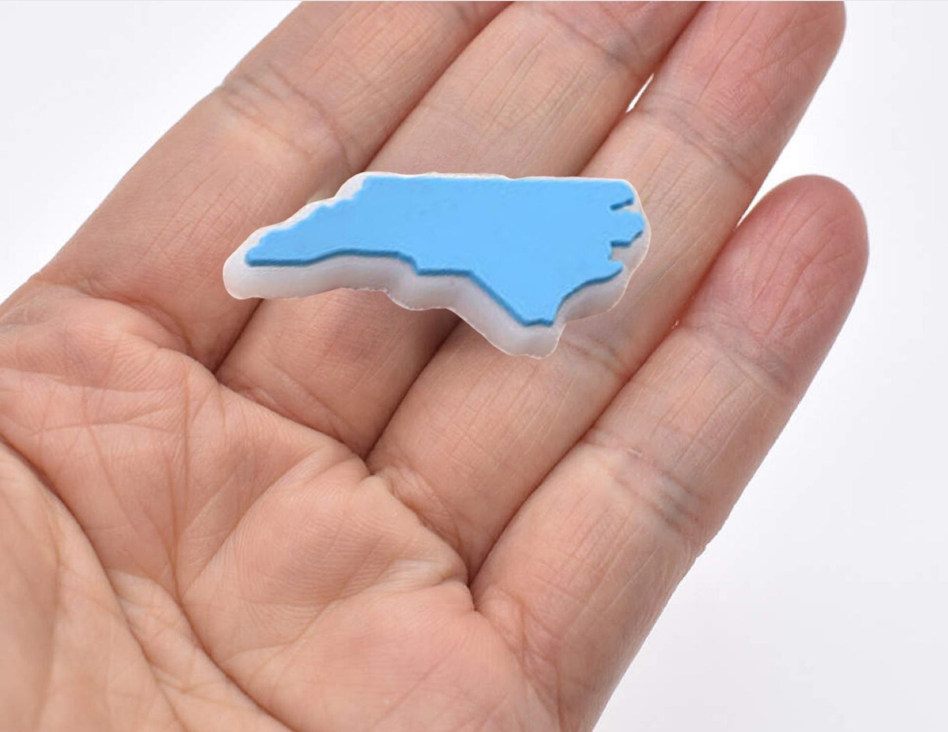 Malcontents North Carolina state Croc charm/Jibbitz: the shape of North Carolina in Carolina blue on palm of hand