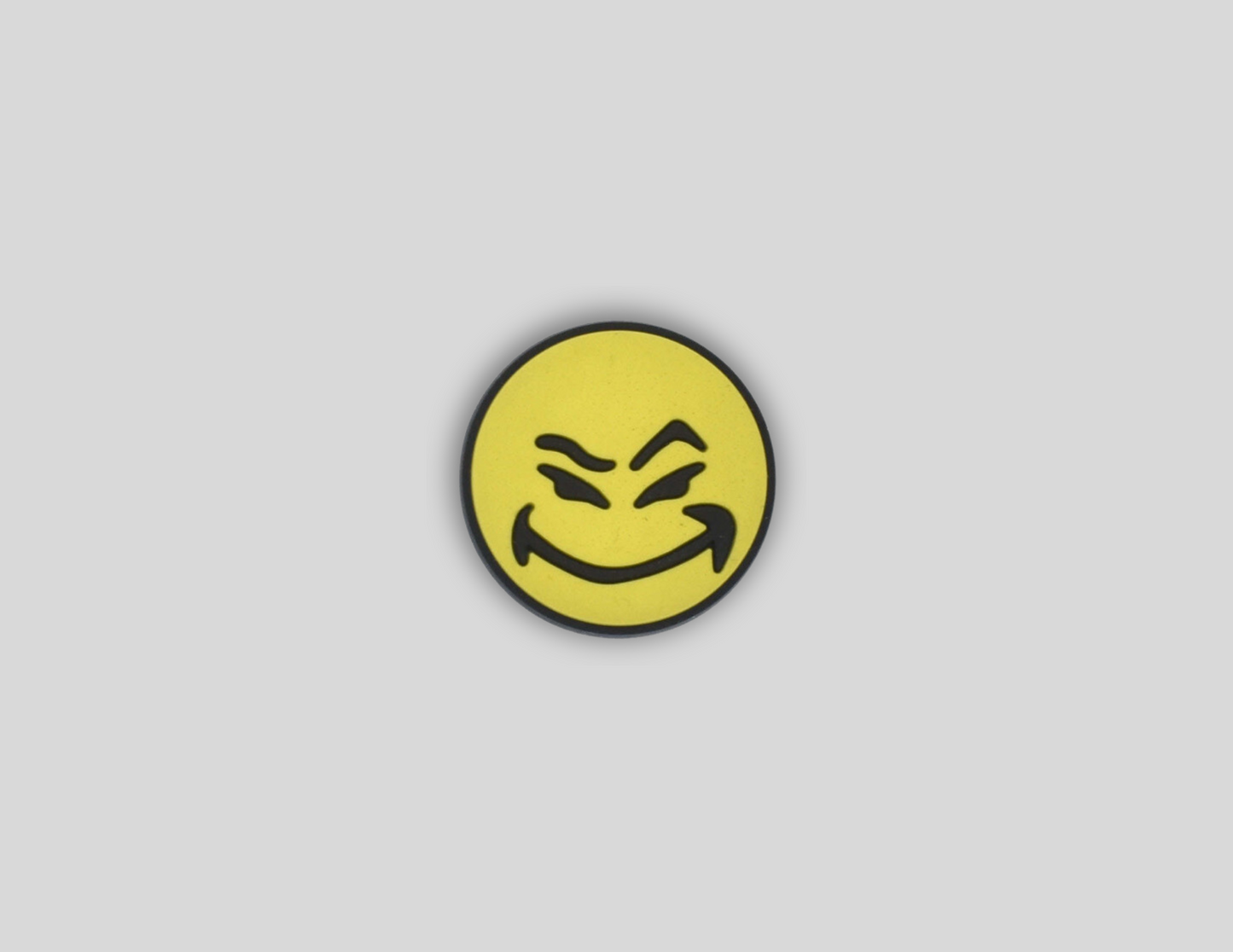 Malcontents Croc Charm shows smiley logo with yellow face and mischievous smile.